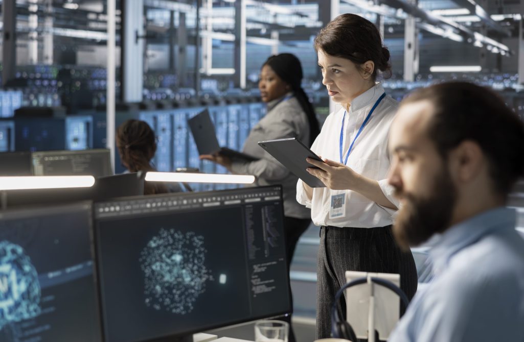System administrators in data center integrating AI driven automation tools, doing maintenance. Staff members in server room using artificial intelligence machine learning models